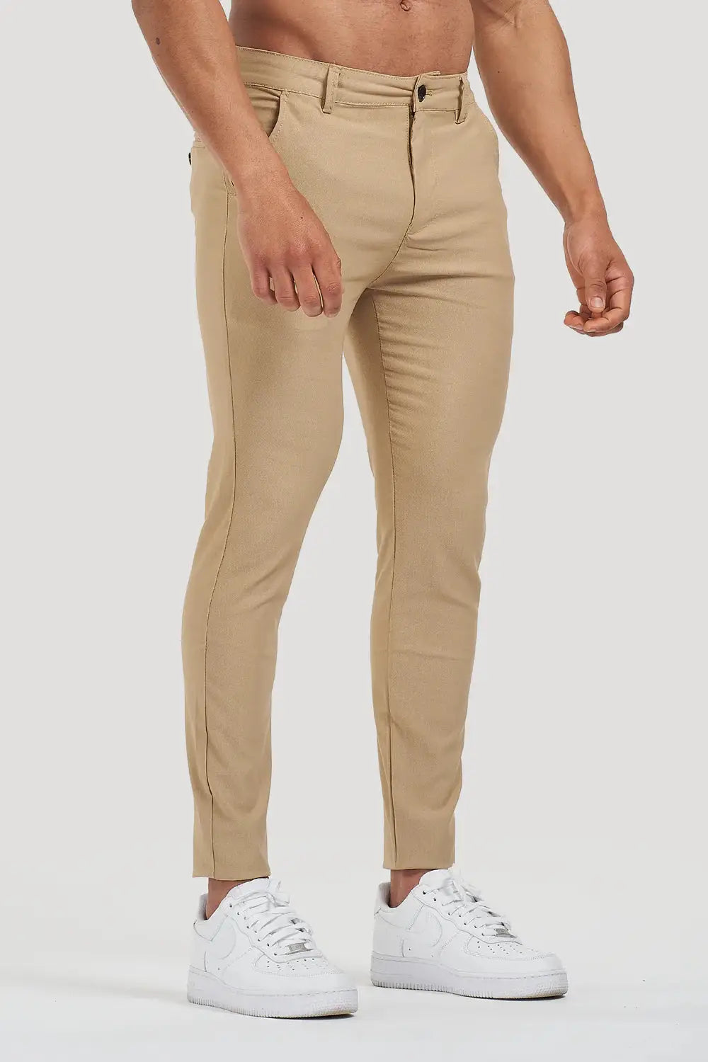 Avari Trousers Cream slim fit styled with white sneakers, offering a blend of elegance and casual comfort.