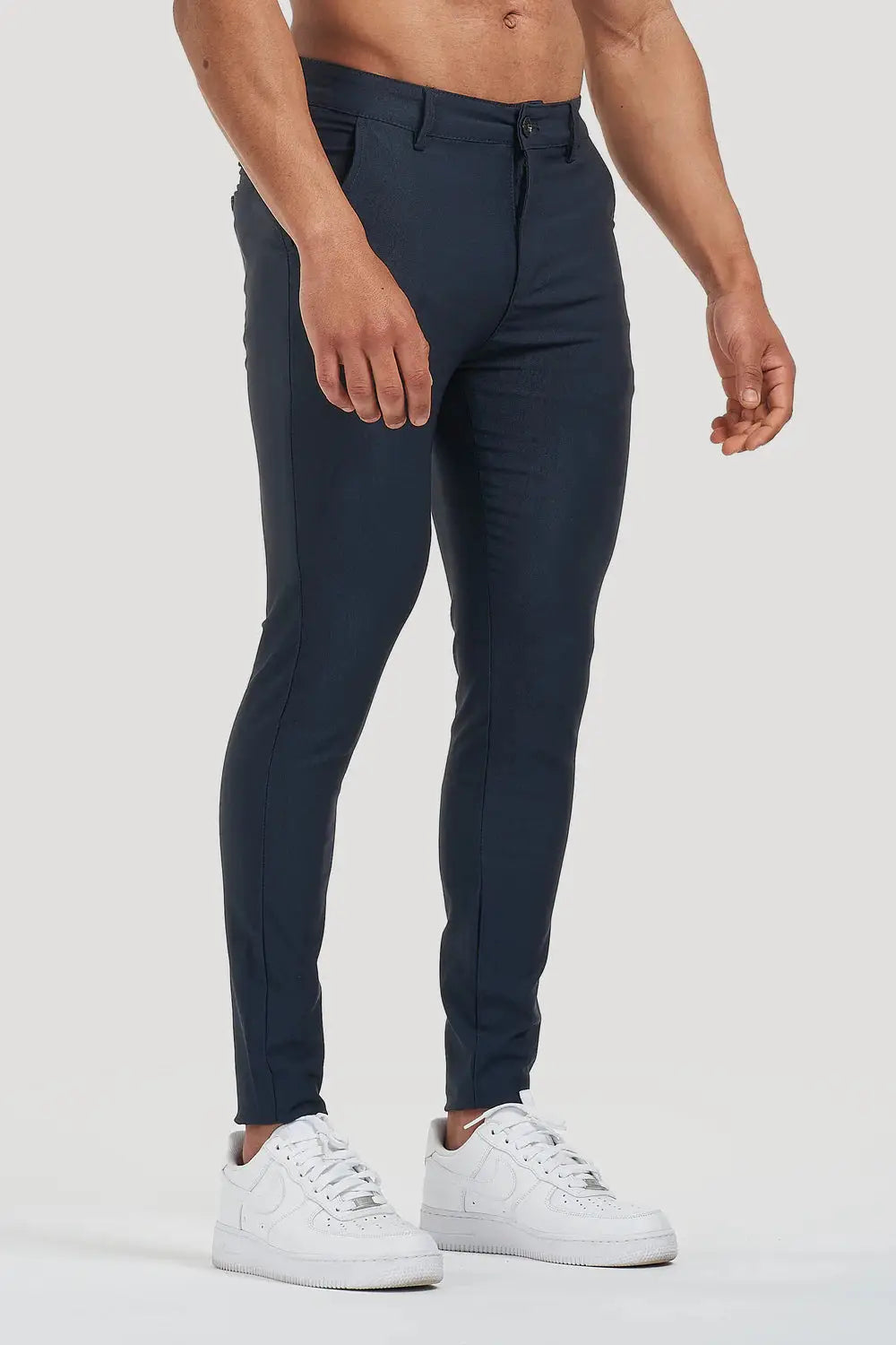 Side view of Avari Trousers in dark blue, emphasizing the slim-fit design and clean tailoring.