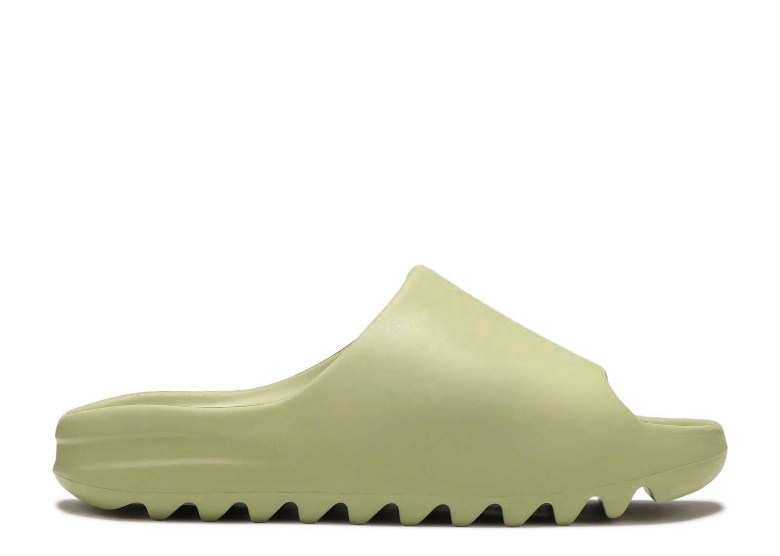 Yeezy Slides Resin 2021 in light green with a minimalist design and ridged outsole, offering comfort and style for casual wear.