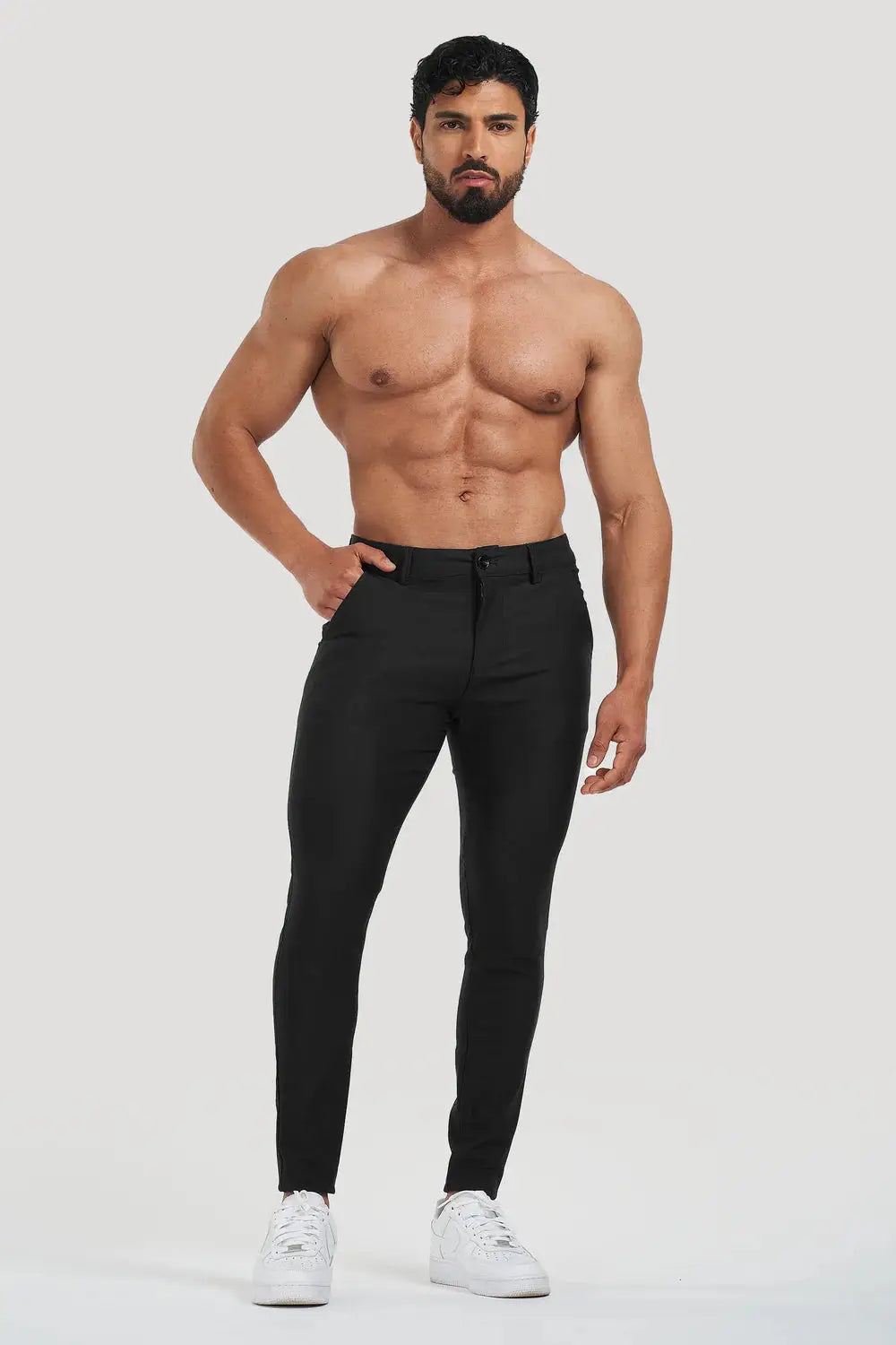 Avari Trousers Black, slim-fit and tapered, modeled with a shirtless style showcasing a comfortable and flexible fit.