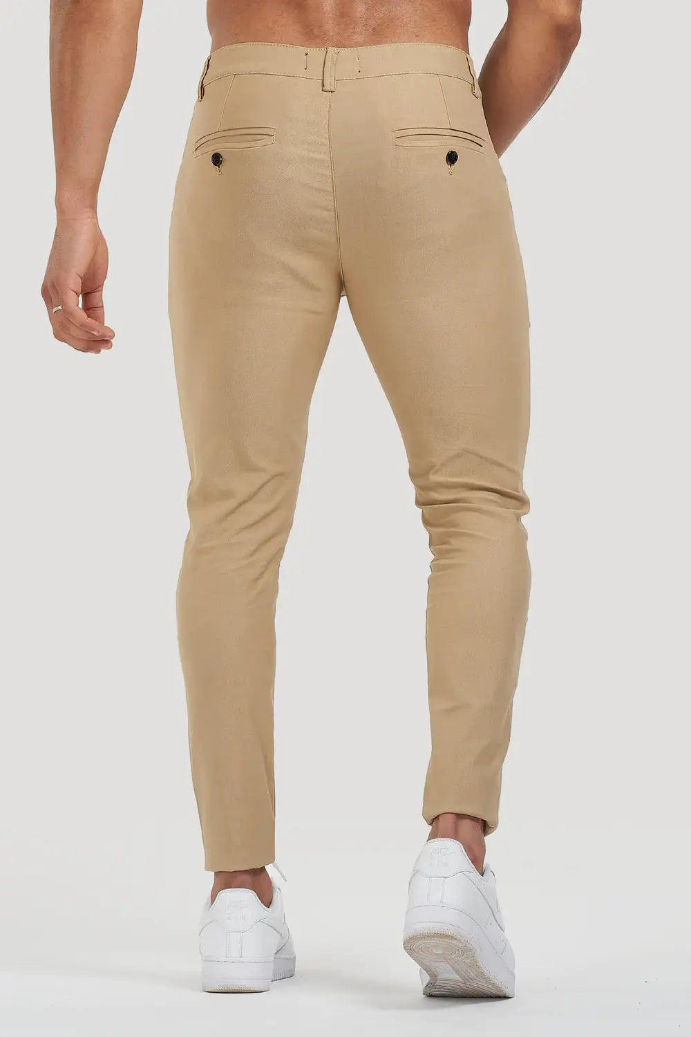 Back view of Avari Trousers Cream slim fit, featuring buttoned pockets and a tailored fit for a polished look.