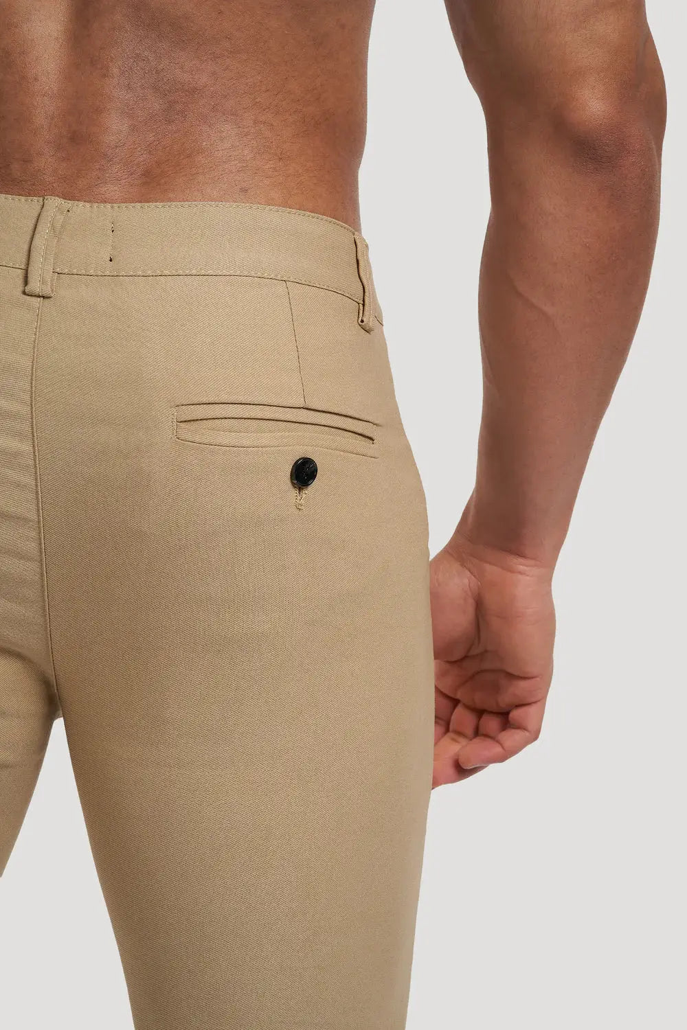 Close-up of Avari Trousers Cream slim fit back pocket detail, highlighting craftsmanship and quality stitching.