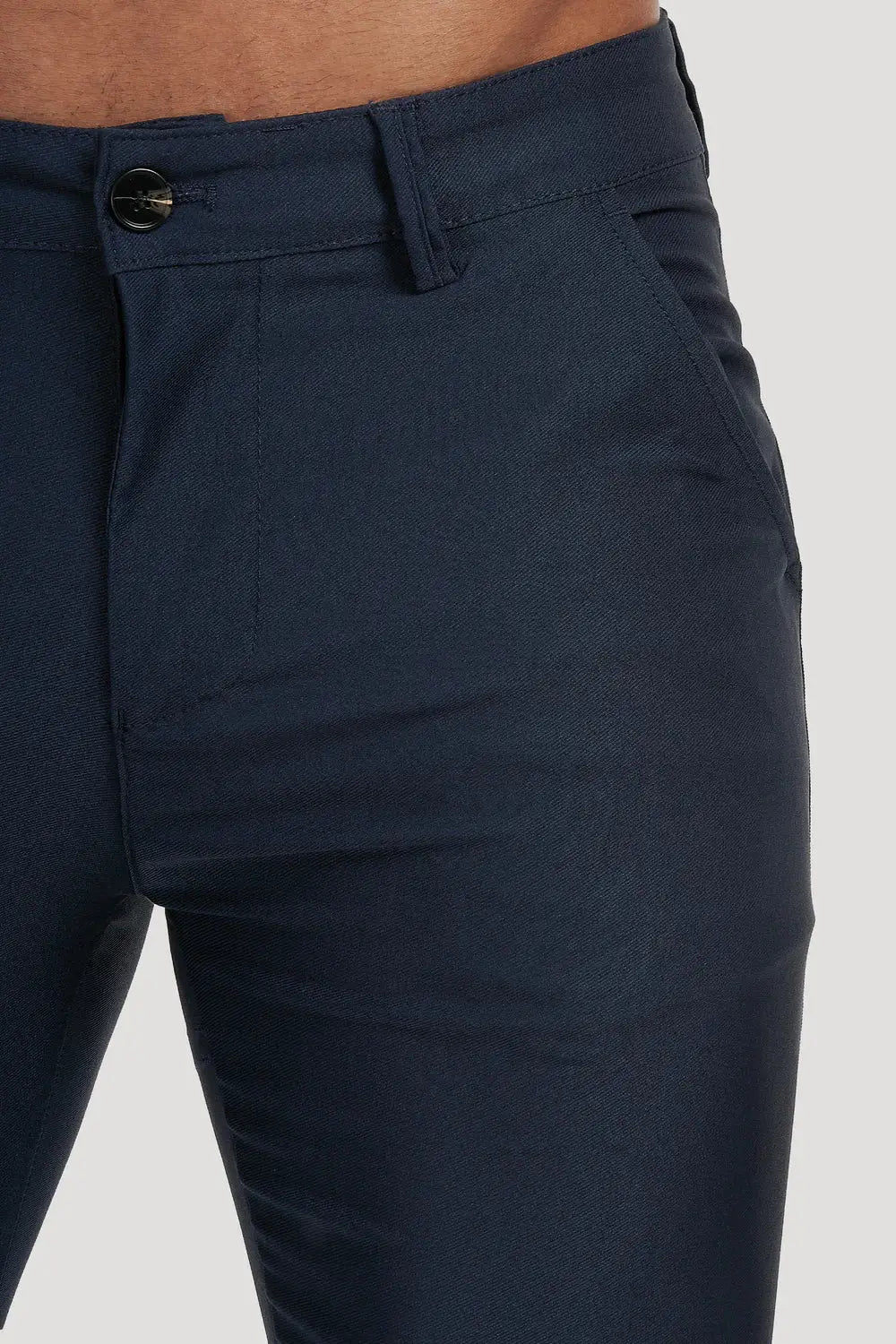 Close-up of Avari Trousers in dark blue, highlighting the durable fabric, front button closure, and pocket details.