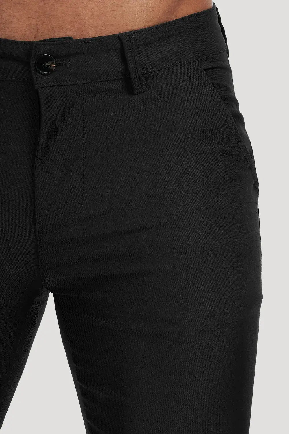 Close-up of Avari Trousers Black, highlighting the button closure, front pockets, and sleek slim-fit design.