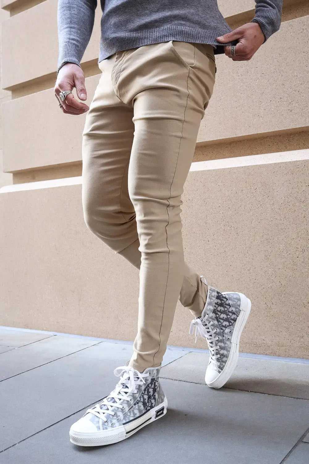 Avari Trousers Cream slim fit styled with patterned sneakers, showcasing a trendy and versatile fashion choice.