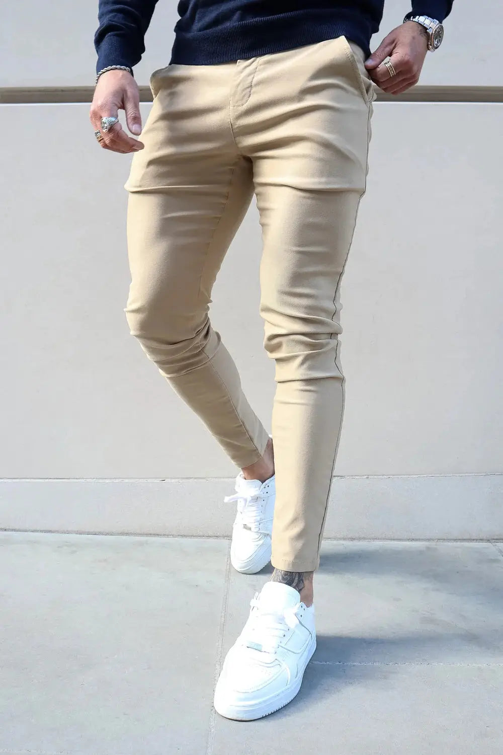 Avari Trousers Cream slim fit paired with white sneakers, perfect for a casual yet stylish outdoor look.