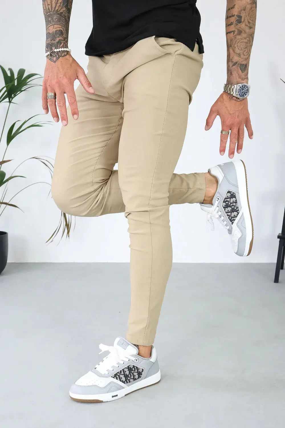 Avari Trousers Cream slim fit paired with casual sneakers, emphasizing flexibility and comfort for active wear.