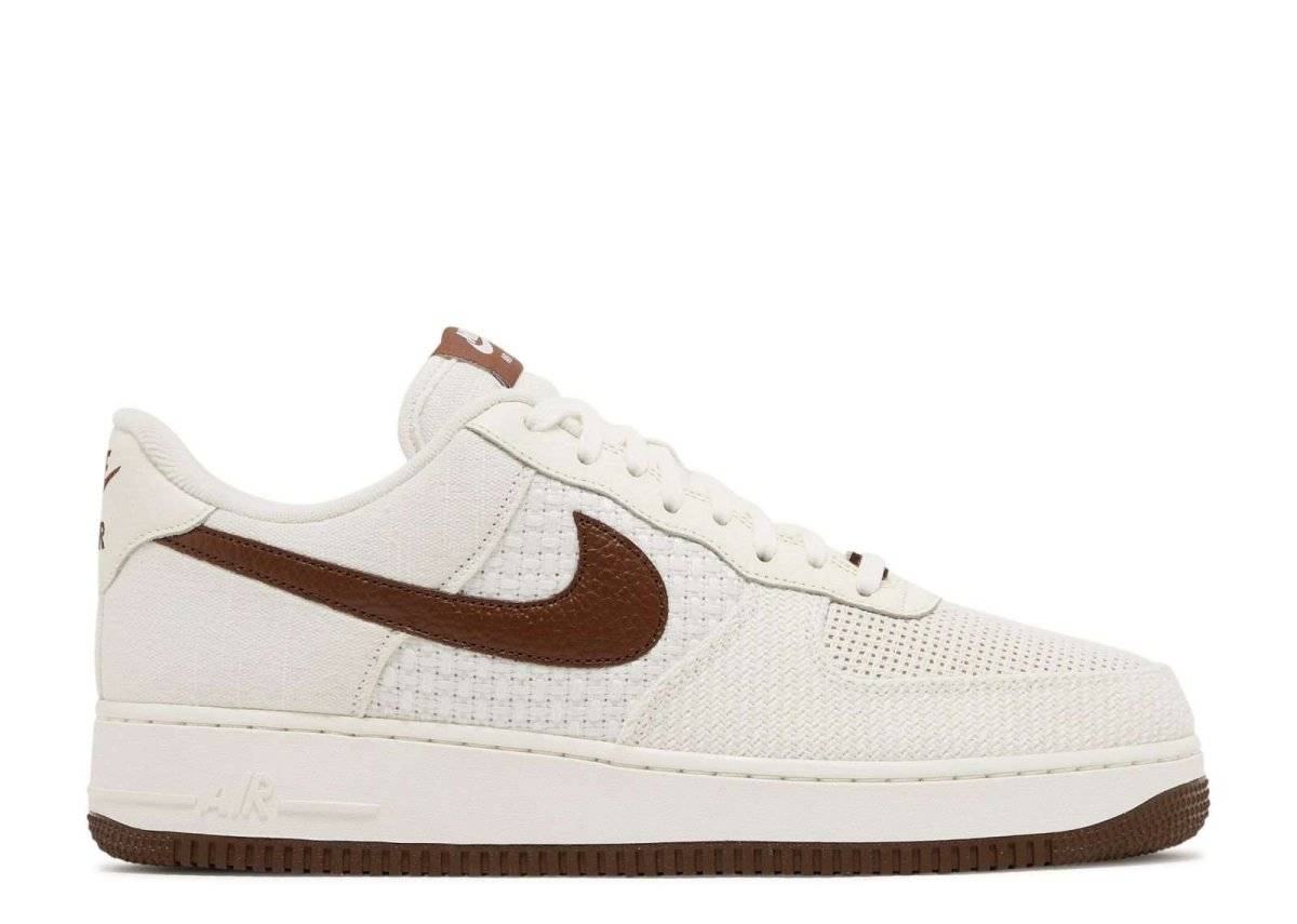 Nike Air Force 1 07 SNKRS Day sneaker in white with brown leather Swoosh, breathable mesh upper, and cushioned sole for comfort.