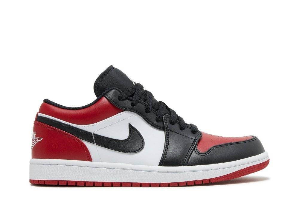 Air Jordan 1 Low Bred Toe sneaker with black, red, and white leather upper, featuring a Wing logo on the heel and Jumpman label on the tongue.