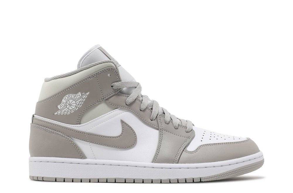 Air Jordan 1 Mid College Grey sneaker featuring a white leather base with grey overlays, iconic Nike swoosh, and mid-top design. Perfect for casual and athletic wear.