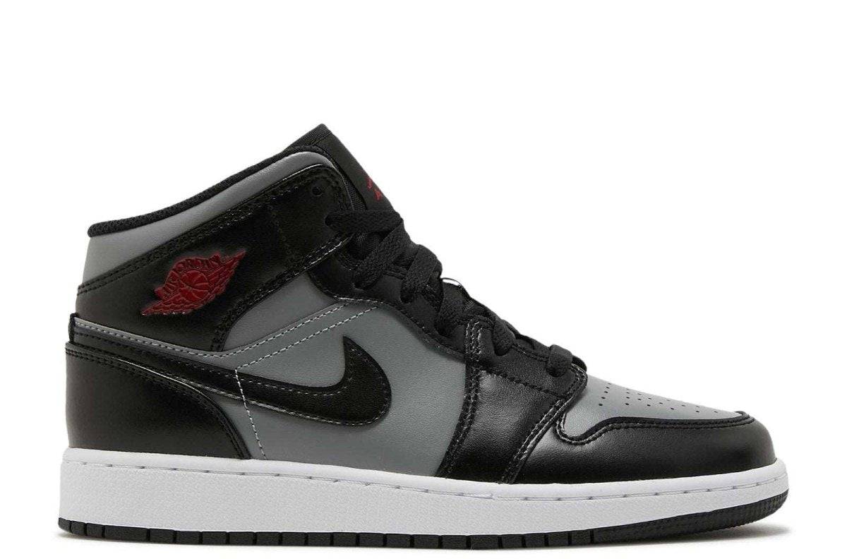 Air Jordan 1 Mid GS Shadow sneaker in black, grey, and red with black laces, red logo, white sole, and black swoosh. Grade school size.