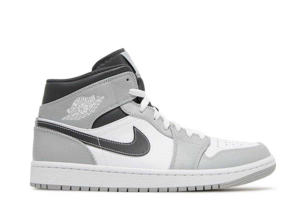 Air Jordan 1 Mid Light Smoke Grey sneakers featuring a grey and white leather upper with black Nike Swoosh, iconic branding, and mid-top design.