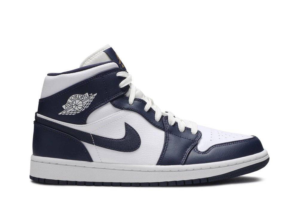 Air Jordan 1 Mid Obsidian sneaker featuring a white leather base with obsidian blue overlays, Nike Swoosh, and cushioned midsole. Perfect for casual wear.