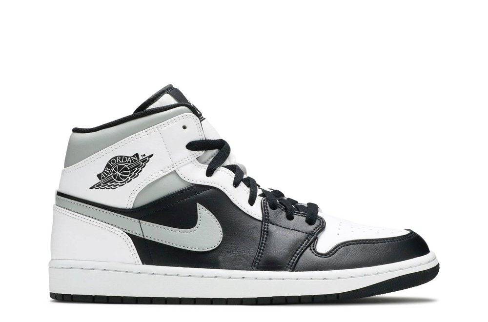 Air Jordan 1 Mid White Shadow sneaker featuring a stylish retro design with a black, white, and gray color mix. Perfect for casual and athletic wear.