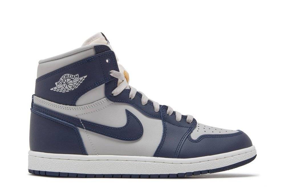 Air Jordan 1 High 85 Georgetown sneaker featuring smooth grey leather upper with College Navy overlays, iconic Nike Swoosh, and vintage design.