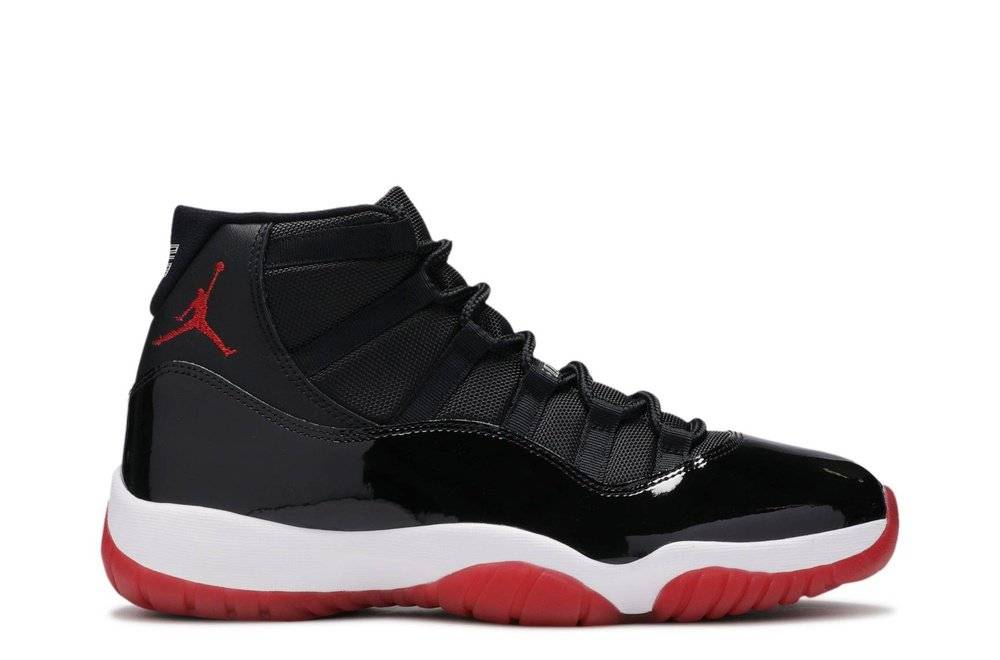 Air Jordan 11 Retro Bred 2019 sneaker featuring black patent leather upper, red outsole, and white midsole. Iconic basketball shoe design.