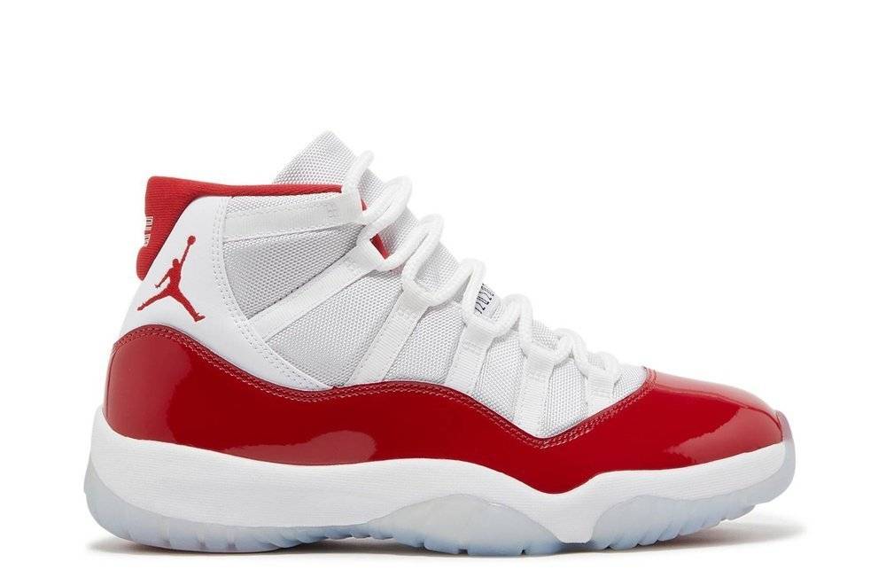 Air Jordan 11 Retro Cherry sneakers featuring a cherry red patent leather overlay, white mesh upper, and icy translucent outsole.