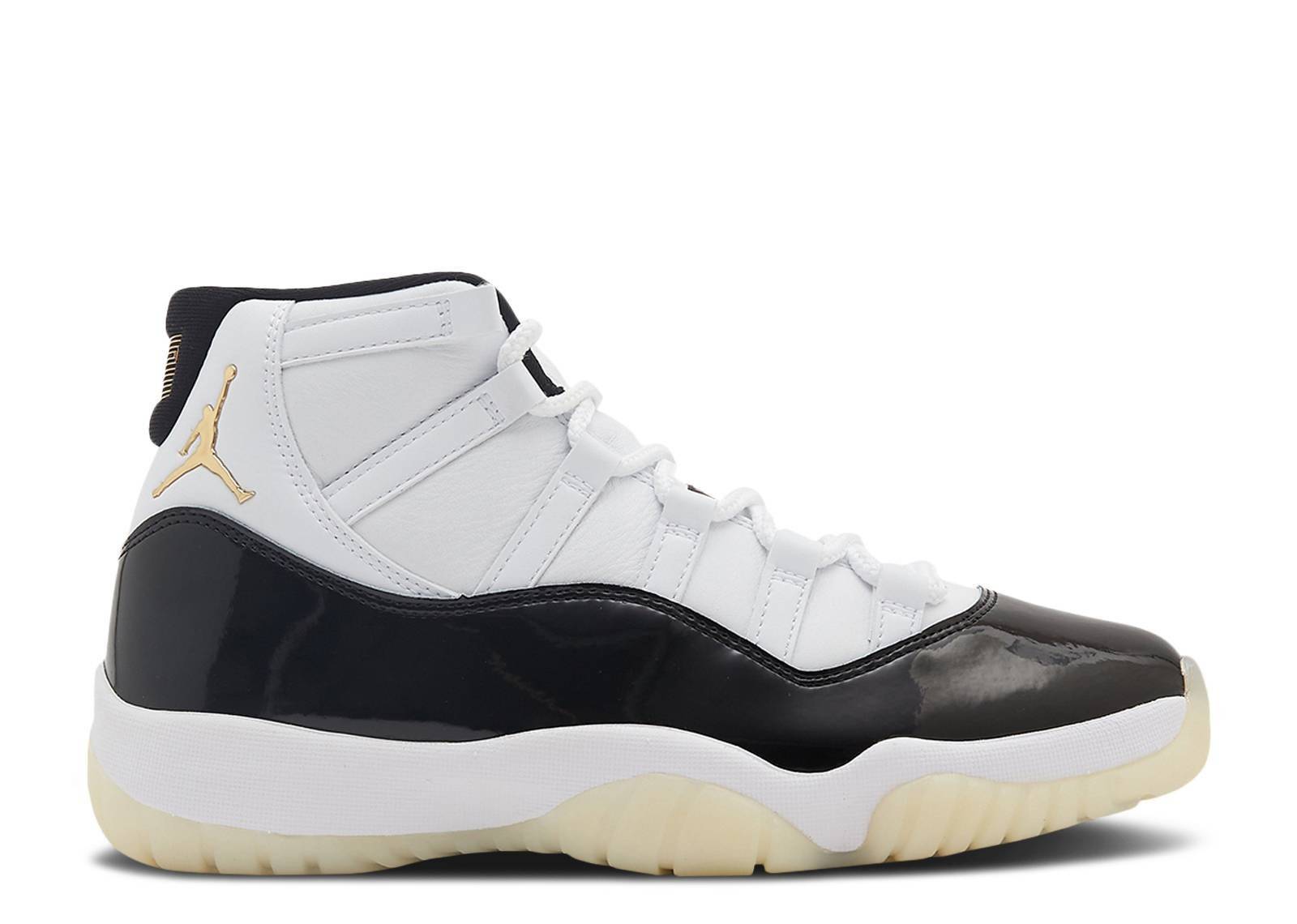 Air Jordan 11 Retro 2023 sneaker in Defining Moments colorway featuring high-cut black patent leather, white upper, and metallic gold accents.