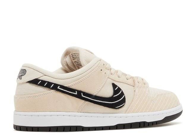 Albino Preto x Dunk Low SB Fossil sneaker with a beige upper, black embroidered Swoosh, and subtle Jiu-Jitsu-inspired details.