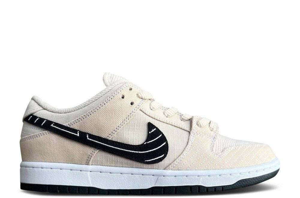 Albino Preto x Dunk Low SB Fossil sneaker featuring a beige heavy gauge canvas upper, black stitched Swoosh, and white midsole.