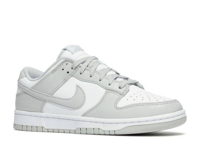 Nike Dunk Low Grey Fog sneaker showcasing a white leather upper, Grey Fog overlays, and laces, angled front-side view.