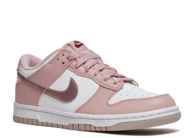 Nike Dunk Low GS Pink Velvet sneaker showcasing white leather, pink overlays, metallic Swoosh, and velvet heel tab, angled front view.