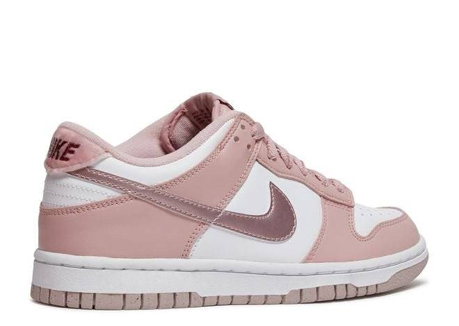 Nike Dunk Low GS Pink Velvet sneaker featuring pink overlays, white leather, metallic Swoosh, and velvet heel tab, rear side view.