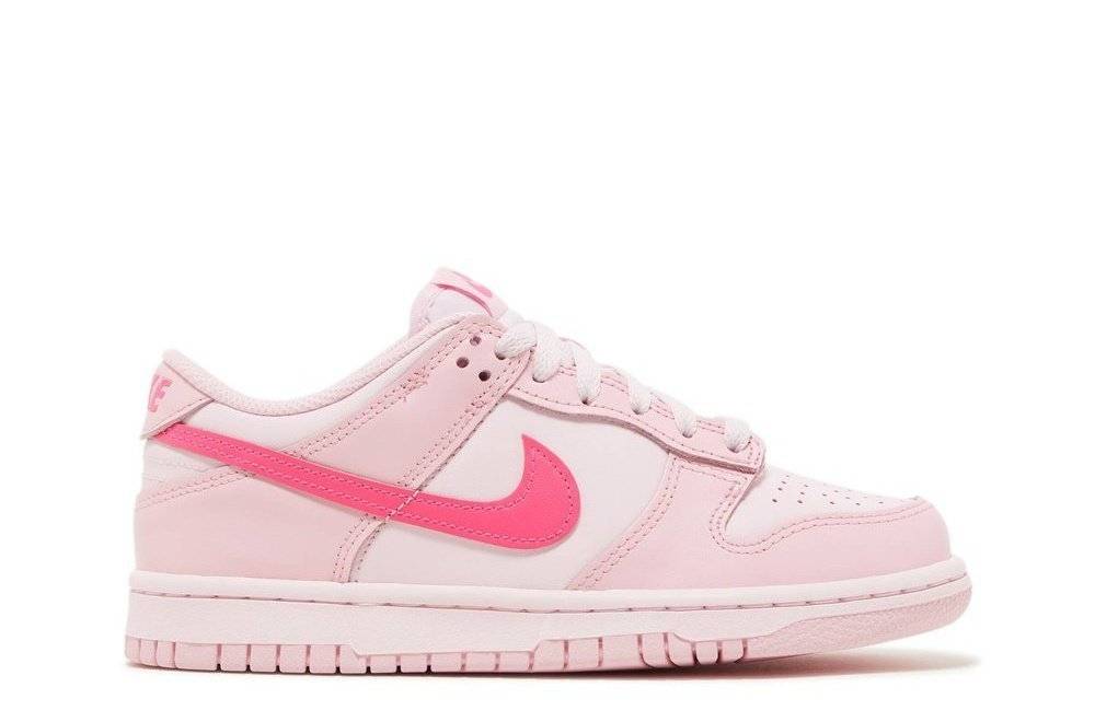 Nike Dunk Low GS Triple Pink sneaker in light pink leather with bold pink Swoosh, side profile view. Youth sizing for stylish footwear.