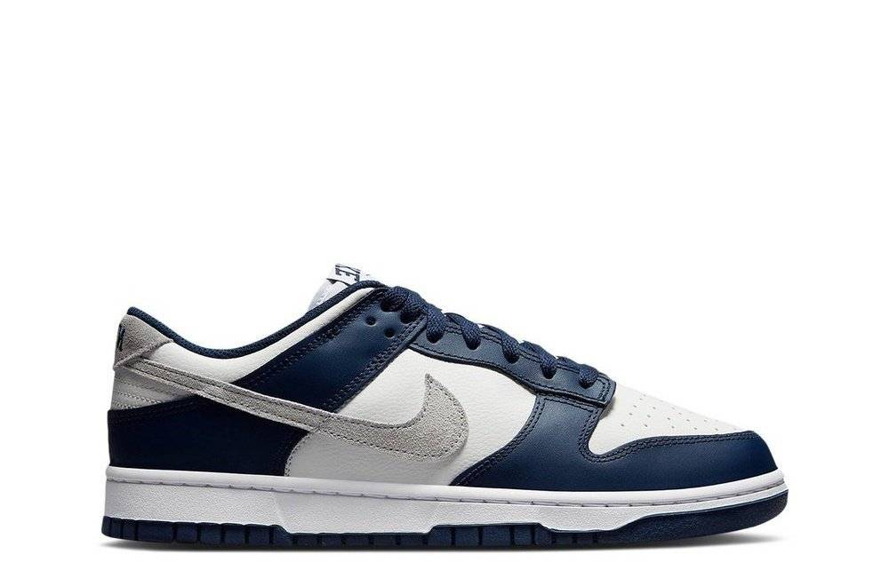 Dunk Low Midnight Navy Smoke Grey sneaker featuring white tumbled leather, grey suede accents, and a navy swoosh. Ideal for casual and streetwear styles.