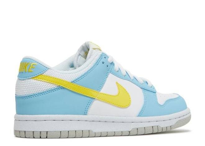 Rear angle of the Nike Dunk Low Next Nature GS Homer sneaker highlighting the yellow Nike branding, light blue overlays, and eco-friendly materials.