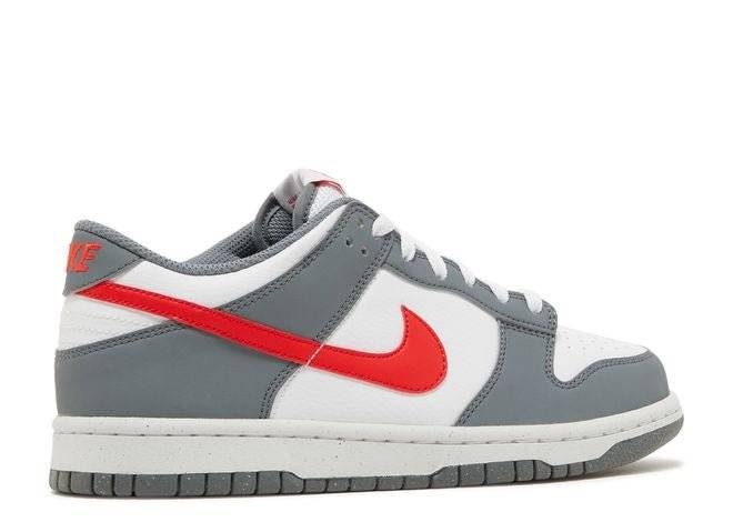 Opposite side view of the Nike Dunk Low Nature GS in grey and white with crimson accents, crafted with 20% recycled materials.