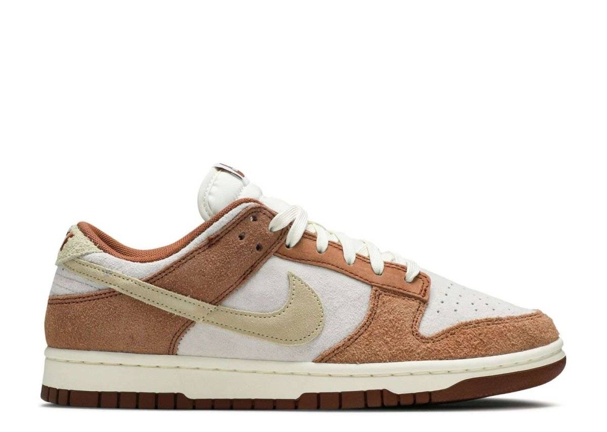 Nike Dunk Low Premium sneakers in sail, curry, and fossil colorway featuring a flat rubber sole, suede overlays, and signature Swoosh design.