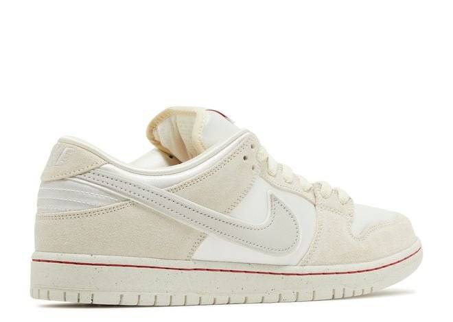 Nike Dunk Low Premium SB City of Love sneaker in light bone with university red accents, opposite side profile view.