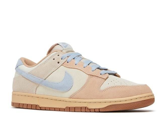 Side view of Dunk Low Sanddrift Blue sneaker with soft suede in neutral tones, light blue accents, and durable gum outsole. Stylish and versatile.