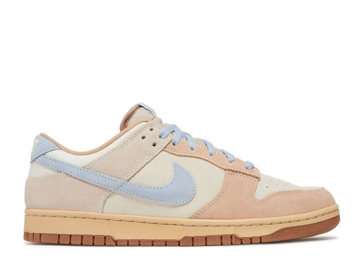 Dunk Low Sanddrift Blue sneaker featuring Coconut Milk suede upper, Armory Blue swoosh, and gum sole. Perfect for casual and sporty looks.