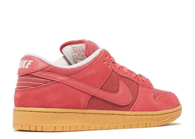 Rear view of Nike Dunk Low SB Adobe sneaker highlighting white Nike branding, adobe red suede, and gum sole details.