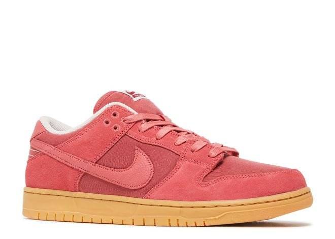 Side angle of Nike Dunk Low SB Adobe sneaker showcasing adobe red suede upper, tonal laces, and durable gum outsole.