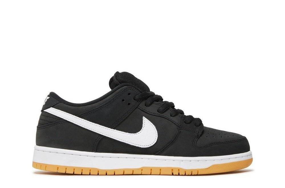 Nike SB Dunk Low Black Gum sneaker with black nubuck upper, white Swoosh, and gum rubber outsole. Classic skate shoe design.