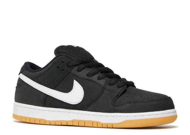 Side view of Nike SB Dunk Low Black Gum sneaker featuring black nubuck material, white Swoosh, and gum sole for durability.