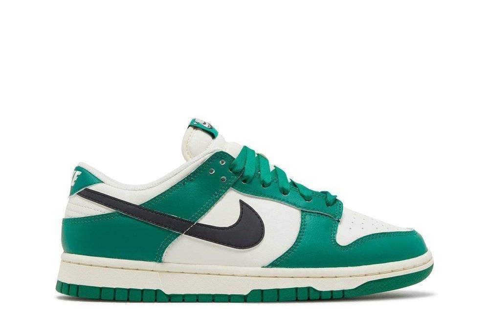 Nike Dunk Low SE Lottery Pack sneaker featuring a white leather base with malachite green overlays, black Swooshes, and a classic low-top silhouette.