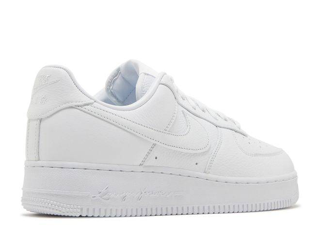 Drake-inspired NOCTA x Air Force 1 Low sneaker in white leather, featuring 'Love You Forever' midsole script, rear side profile.