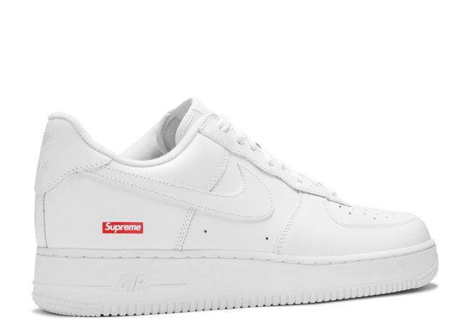 Supreme x Air Force 1 Low in white, highlighting the clean silhouette and red Supreme logo on the lateral heel. Perfect for streetwear enthusiasts.