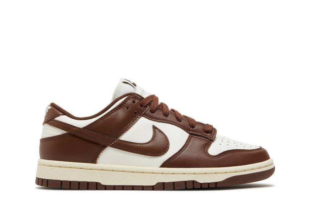 Nike Wmns Dunk Low Cacao Wow sneakers in brown and white leather, featuring a low-top design and signature Swoosh logo on the side.