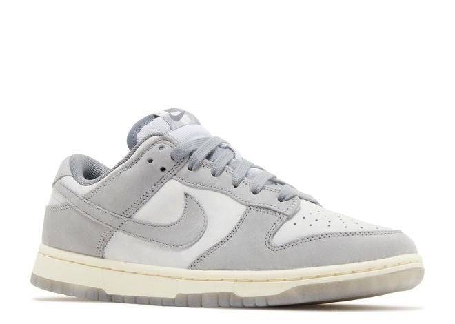 Nike Dunk Low Cool Grey sneaker with a two-tone grey upper, padded tongue, and white midsole. Stylish and comfortable for everyday use.