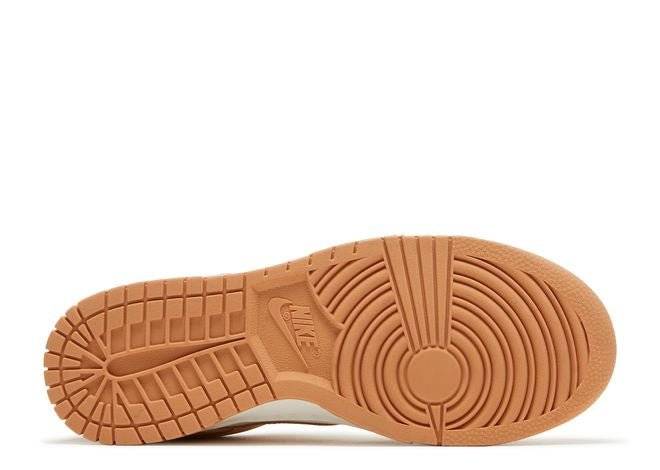 Outsole of Nike Dunk Low Harvest Moon sneaker with durable light brown rubber and circular traction pattern for grip and stability.