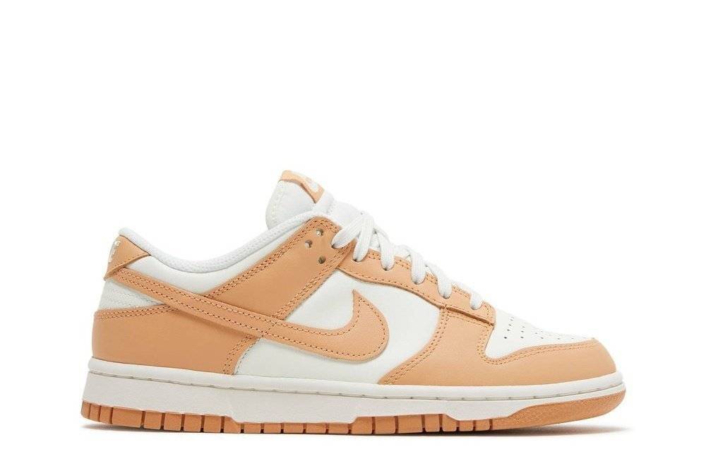 Nike Dunk Low Harvest Moon women's sneaker with white leather base and light brown overlays, featuring a low-top design and classic Swoosh logo.