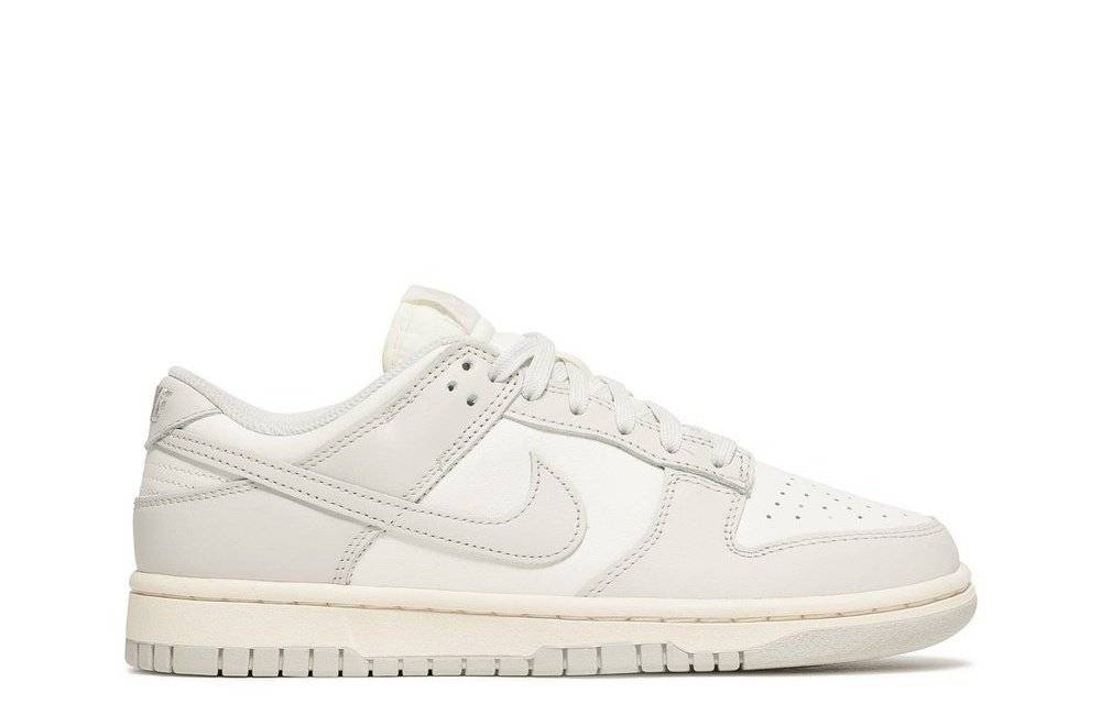 Wmns Dunk Low Light Bone sneaker by Nike featuring a minimalist design with light bone and coconut milk hues. Perfect for streetwear and casual wear.