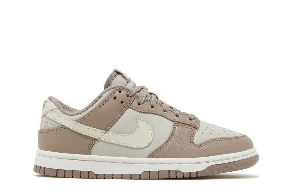 Wmns Dunk Low Moon Fossil sneaker featuring black leather base, beige overlays, and a durable white midsole with brown outsole. Iconic Nike design.