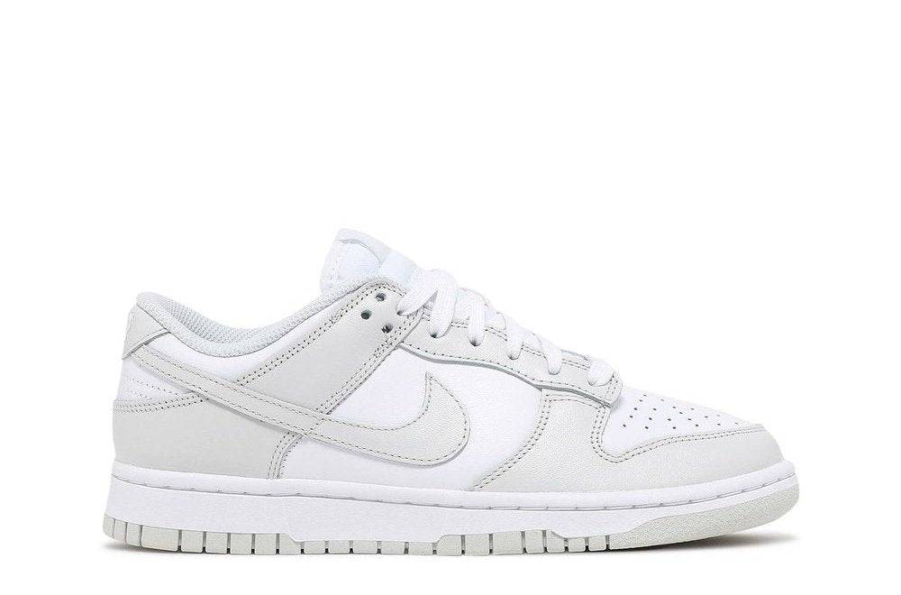 Wmns Dunk Low Photon Dust sneaker in white and light gray with a low-top design, featuring a sleek leather upper and Nike Swoosh branding.