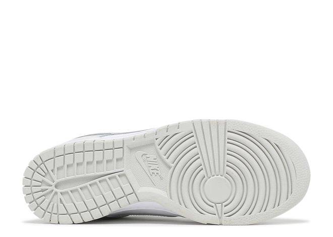 Outsole of the Wmns Dunk Low Photon Dust sneaker, featuring a textured rubber sole for traction and Nike branding in the center.